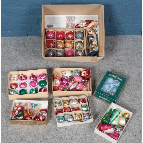 268 - A box of Christmas baubles. Including vintage examples, etc.