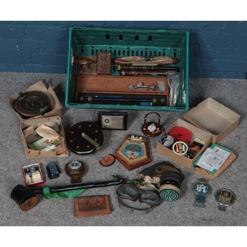 273 - A large box of collectables. Including flash camera table lighter, fishing feels and hooks, whistles... 