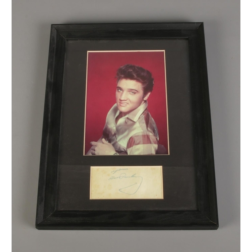 34 - A framed Elvis Presley autograph along with photograph. Dimensions including frame 25cm x 33.5cm.