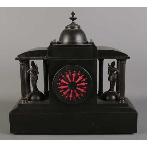 36 - A black slate mantel clock, formed as a Roman colosseum, with Corinthian pillars surrounding soldier... 