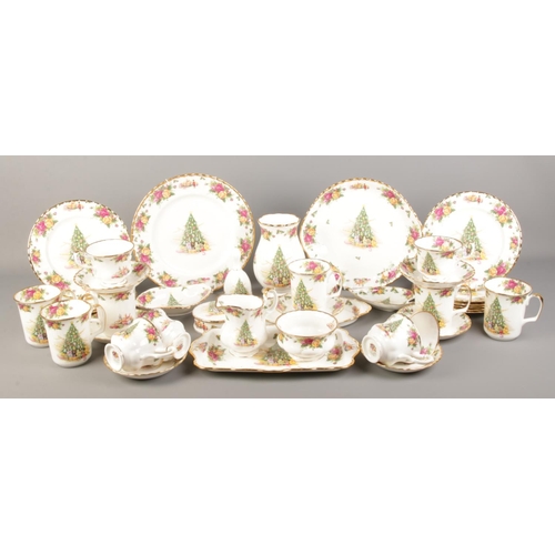 4 - A good collection of Royal Albert ceramics in the 'Christmas Magic' pattern, to include cups and sau... 