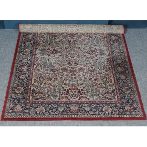 309 - A Ryalux Carpets cream ground wool rug. 240cm x 170cm.