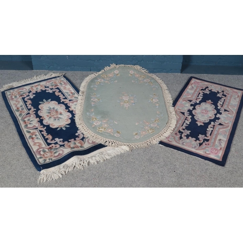 311 - A Jalna green ground rug along with two floral decorated blue ground runners.