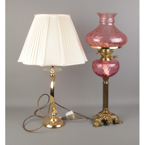 329 - A decorative pink glass paraffin lamp with one other table lamp.