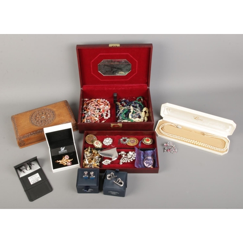 48 - A box of costume jewellery. Including boxed pearl necklace, brooches, Swarovski, cuff links, clip on... 