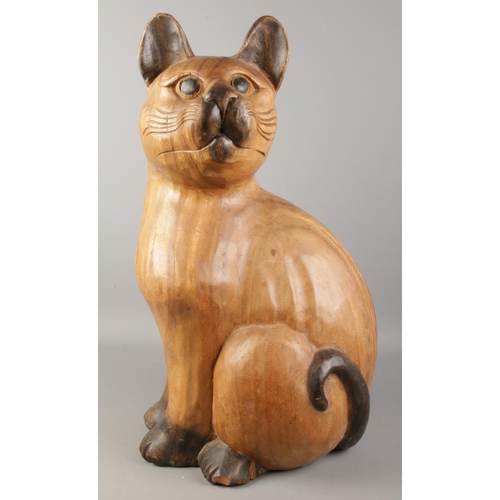 336 - A large carved wooden model of a cat. Height 61cm.