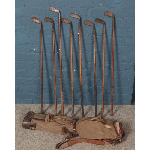 349 - A quantity of vintage golf clubs. Including W H Wooler, etc.