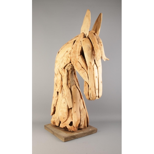 5 - A large decorative wooden sculpture of a horse's head. Approx. 90cm tall including base.