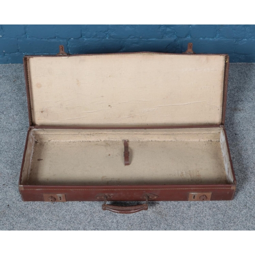 354 - A long leather suitcase. Approx. 74cm x 29cm x 10cm.