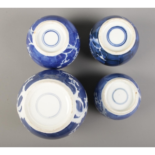 58 - Four blue and white prunus pattern ginger jars, one with cover. All with concentric circle marks to ... 