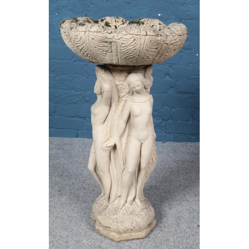 363 - A reconstituted garden ornament with figural base depicting three maidens. 80cm.