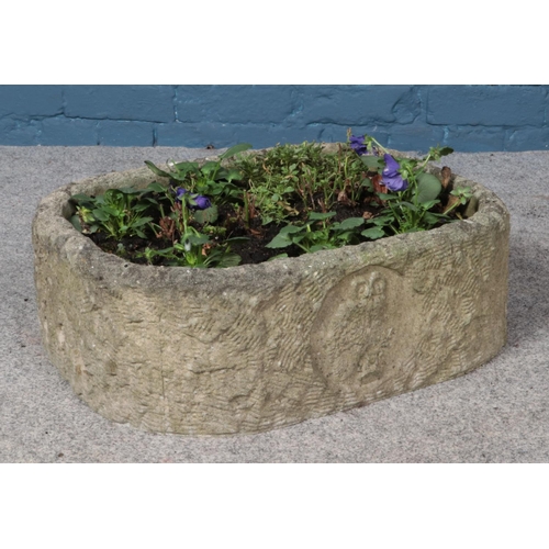 366 - A concrete planter with bird detailing to the front. Height 20cm, Width 60cm, Depth 45cm.