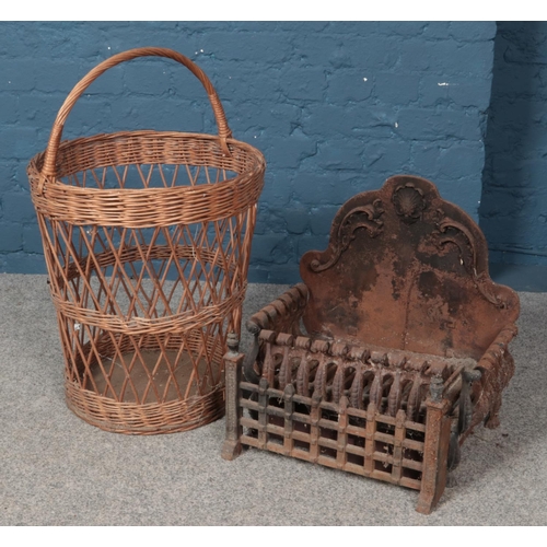 368 - A Cast iron fire grate along with a wicker log basket.