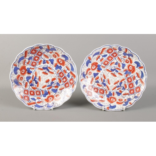 60 - A pair of fluted Japanese Imari dishes, decorated in flowers. Back of the plates feature waterbirds ... 