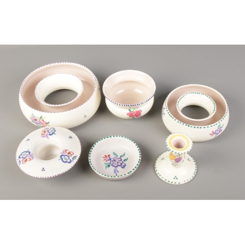 68 - A quantity of Poole pottery including candlestick holder and small bowls.