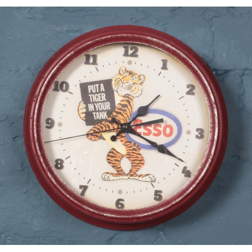 421 - A quartz wall clock with dial advertising Esso. Diameter 30.5cm.