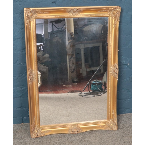 427 - A gilt framed mirror. Dimensions including frame 35cm x 61cm.