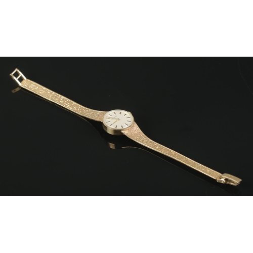 446 - A Ladies 9ct Gold Tissot manual wind wristwatch, with baton marker dial, textured gold bracelet stra... 