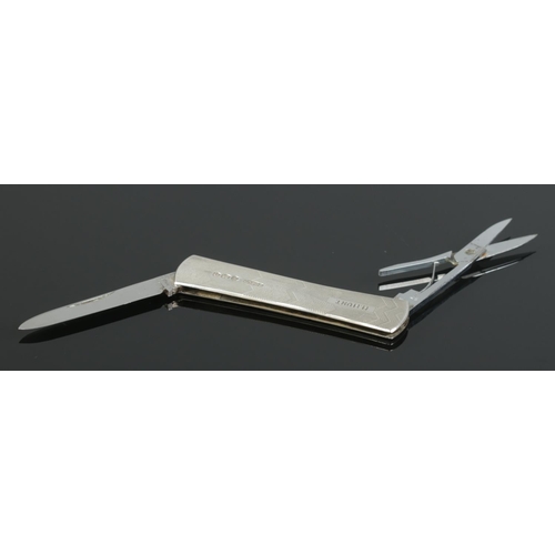 460 - A silver bodied pen knife, with stainless steel blade and miniature scissors attachment. Body assaye... 