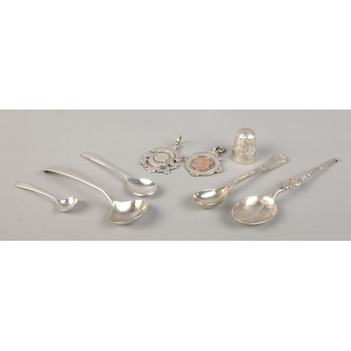 461 - A collection of silver and white metal oddments, to include two fobs, teaspoons and Charles Horner t... 