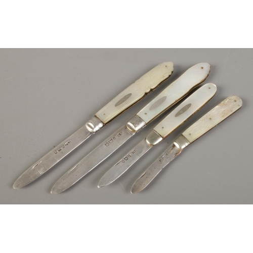 493 - Four silver bladed and mother of pearl fruit knives, two with engraved crests. All assayed for Sheff... 