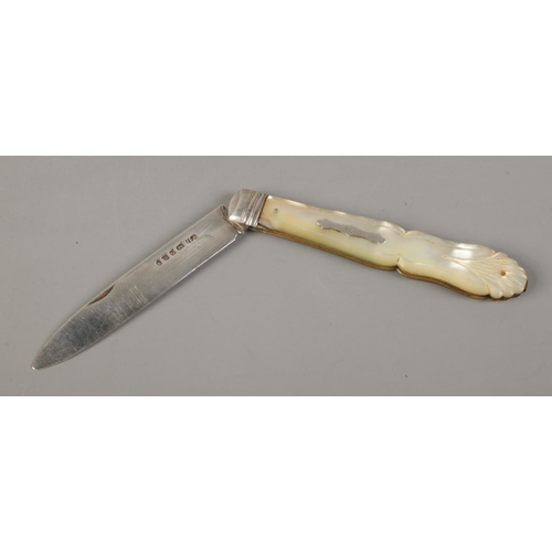 497 - A large Victorian silver bladed and mother of pearl fruit knife with monogrammed crest and shell han... 