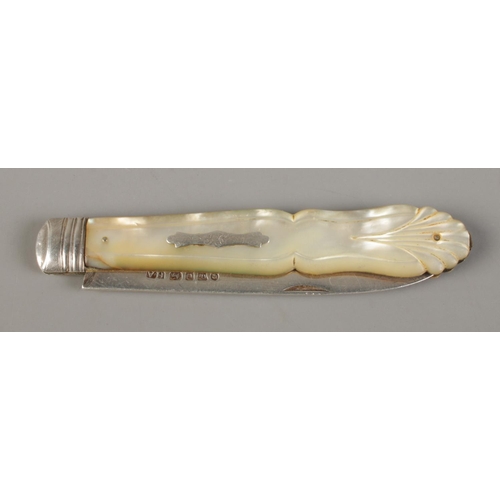 497 - A large Victorian silver bladed and mother of pearl fruit knife with monogrammed crest and shell han... 