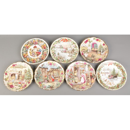 8 - A collection of seven Royal Albert Christmas cabinet plates. To include 'The Coaching Inn at Christm... 