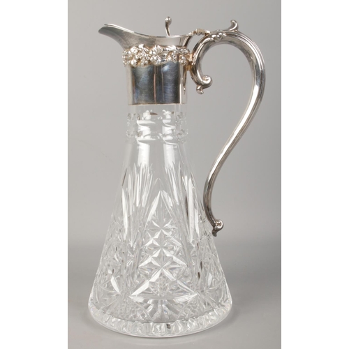 521 - A French silver mounted and cut glass claret jug, with grapevine decoration and scrolled handle. Min... 