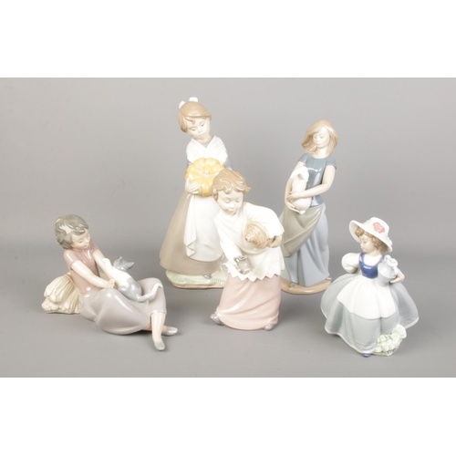 524 - Five Nao by Lladro figures. Including large girl with pumpkins, girl with cat, girl with rabbit, etc... 