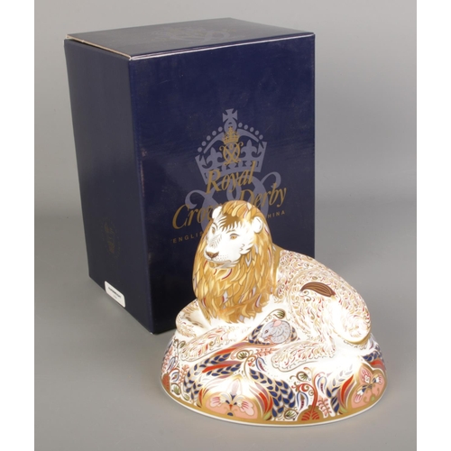 525 - A boxed Royal Crown Derby paperweight formed as a Lion. With silver stopper.