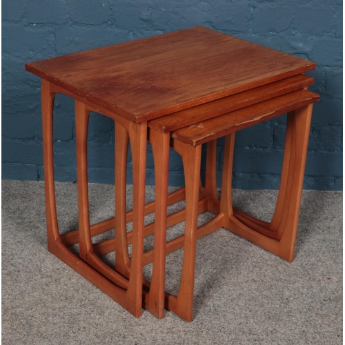 544 - A set of three GPlan style teak nesting tables. Largest table dimensions 56.5cm x 41cm x 51cm.