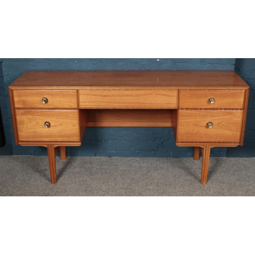 546 - A five drawer sideboard raised on tapered legs. 150cm x 41cm x 72cm.