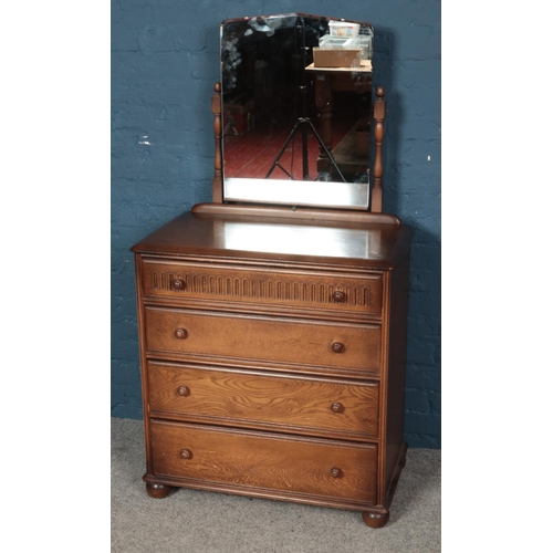 547 - A carved oak two piece bedroom suite. Comprising of a wardrobe and a dressing table.