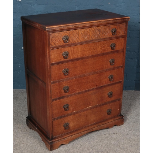 548 - A carved oak chest of six drawers. With quatrefoil decoration. (140cm x 78cm)