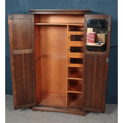 549 - An Old Charm carved oak three piece bedroom suite. Comprising of two wardrobes and dressing table.