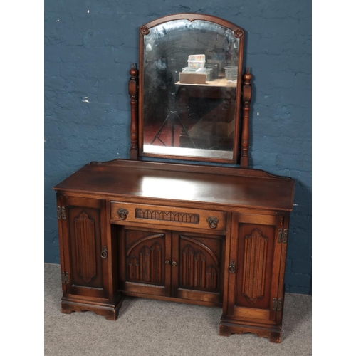 549 - An Old Charm carved oak three piece bedroom suite. Comprising of two wardrobes and dressing table.