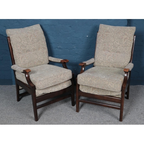 551 - A pair of mahogany framed armchairs. With floral upholstery.