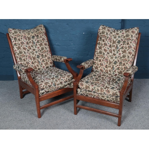 552 - A pair of mahogany framed armchairs. With floral upholstery.