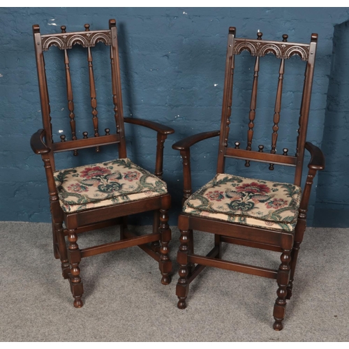 555 - A pair of carved Ercol armchairs.