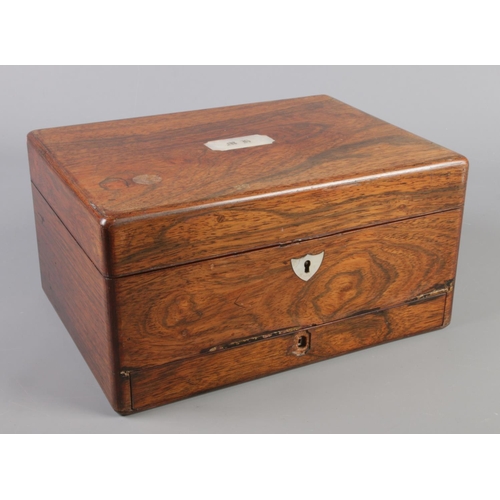 119 - A Victorian rosewood box with mother of pearl inlay and fitted interior.