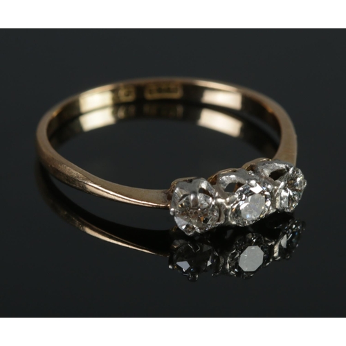 347 - An 18ct gold and platinum diamond three stone ring. Size  O. 1.74g.