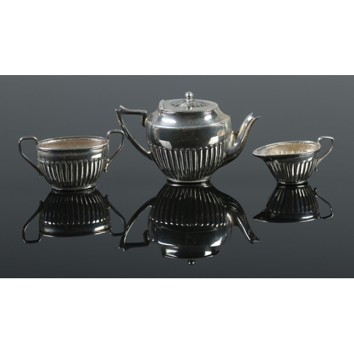 456 - A silver miniature tea set, comprising of tea pot, sugar bowl and cream jug. Stamped 925.