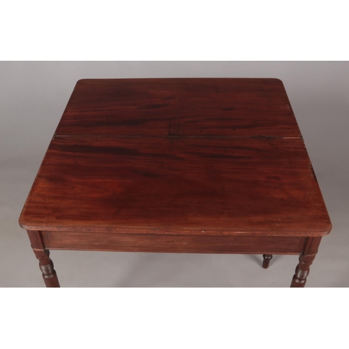 490 - A Georgian mahogany fold over tea table with turned supports.