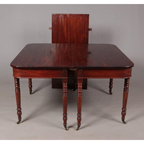 491 - A Georgian mahogany D end dining table raised on turned supports. Length extended 181cm, Width 114cm... 