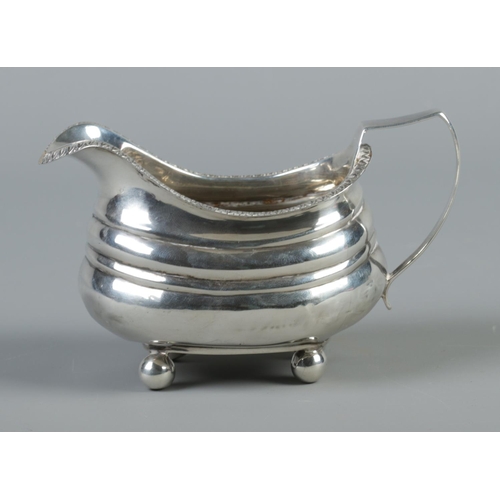 462 - A George III silver cream jug raised on four ball feet. Assayed London 1813. 114g.