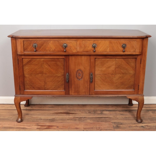 492 - A mahogany sideboard. With carved central motif decoration. (95cm x 137cm)