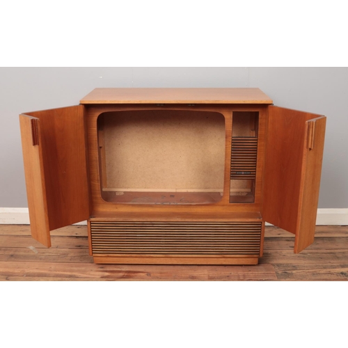 502 - A vintage teak Decca Colour TV cabinet with folding hinged doors, on casters. Height: 78cm, Width: 7... 