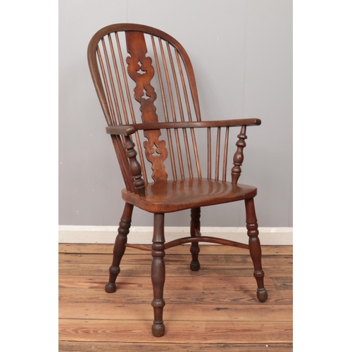 503 - An ash/elm Windsor arm chair, with pierced splat and end turned supports.