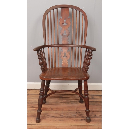 503 - An ash/elm Windsor arm chair, with pierced splat and end turned supports.